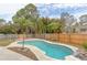 Inviting kidney-shaped pool with concrete decking at 102 Shoreview Ln, Oldsmar, FL 34677