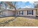 House exterior showcasing beige siding, black shutters, and a landscaped yard at 12575 Maleo Rd, Weeki Wachee, FL 34614