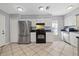 Kitchen features stainless steel appliances and white cabinets at 12575 Maleo Rd, Weeki Wachee, FL 34614