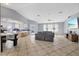 Open living room with a large sectional sofa and view into the kitchen at 12575 Maleo Rd, Weeki Wachee, FL 34614