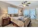 Main bedroom with sliding doors to a patio at 13100 Pebble Beach Cir, Hudson, FL 34667