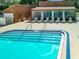 Inviting pool area with shaded seating and lounge chairs at 13100 Pebble Beach Cir, Hudson, FL 34667