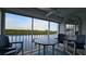 Balcony with water view, table, and chairs at 18325 Gulf Blvd # 407, Redington Shores, FL 33708
