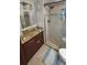 Updated bathroom with granite vanity, large shower, and tiled floors at 18325 Gulf Blvd # 407, Redington Shores, FL 33708