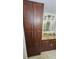 Bathroom with tall wood cabinets and granite countertop at 18325 Gulf Blvd # 407, Redington Shores, FL 33708