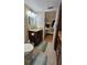 Bathroom with granite vanity, toilet, and view of bedroom at 18325 Gulf Blvd # 407, Redington Shores, FL 33708