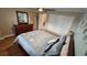 Bedroom with dresser, hardwood floors, and large closet at 18325 Gulf Blvd # 407, Redington Shores, FL 33708