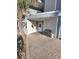 Condominium building entrance with a covered walkway and bench at 18325 Gulf Blvd # 407, Redington Shores, FL 33708