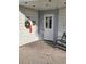 Condominium building entrance with a wreath and bench at 18325 Gulf Blvd # 407, Redington Shores, FL 33708