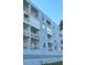 Light blue building with multiple balconies and white railings at 18325 Gulf Blvd # 407, Redington Shores, FL 33708