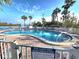 Relaxing kidney-shaped pool with surrounding deck and lounge chairs at 18325 Gulf Blvd # 407, Redington Shores, FL 33708
