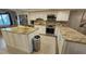 Granite kitchen island and stainless steel appliances at 18325 Gulf Blvd # 407, Redington Shores, FL 33708