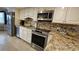 Kitchen with granite countertops and stainless steel appliances at 18325 Gulf Blvd # 407, Redington Shores, FL 33708