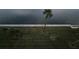 Overlooking calm water, this property boasts a lush lawn and a single palm tree at 18325 Gulf Blvd # 407, Redington Shores, FL 33708