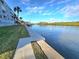 Lovely waterfront view with concrete walkway, lush grass and palm trees at 18325 Gulf Blvd # 407, Redington Shores, FL 33708