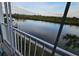 Stunning view of the canal from private balcony, featuring boats and lush greenery at 18325 Gulf Blvd # 407, Redington Shores, FL 33708