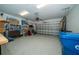 Spacious two-car garage with ample storage shelving and space for additional items at 20108 Sea Glass Cir, Land O Lakes, FL 34638