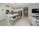 Modern kitchen with white cabinets, quartz countertops, and a breakfast bar at 20108 Sea Glass Cir, Land O Lakes, FL 34638