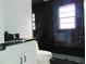 Modern bathroom with black marble tile and white vanity at 214 W 109Th Ave, Tampa, FL 33612