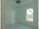 Bright bedroom with window, ceiling fan and marble-look floors at 214 W 109Th Ave, Tampa, FL 33612
