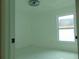 Well-lit bedroom with window and marble-look floors at 214 W 109Th Ave, Tampa, FL 33612
