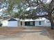 Newly renovated home with a modern exterior and driveway at 214 W 109Th Ave, Tampa, FL 33612