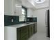 Modern kitchen with teal tile backsplash and stainless steel appliances at 214 W 109Th Ave, Tampa, FL 33612