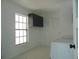 Bright laundry room with washer, dryer, cabinets, and large window at 214 W 109Th Ave, Tampa, FL 33612