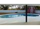 Kidney-shaped pool with a red barn shed in the background at 214 W 109Th Ave, Tampa, FL 33612