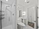 Modern bathroom with glass shower, pedestal sink, and tiled floors at 226 5Th N Ave # 1106, St Petersburg, FL 33701