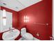 Modern half bathroom with red walls and white fixtures at 226 5Th N Ave # 1106, St Petersburg, FL 33701