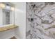 Updated bathroom with a marble shower and white vanity at 2267 Heron Cir, Clearwater, FL 33762