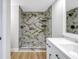 Updated bathroom with a marble shower and white vanity at 2267 Heron Cir, Clearwater, FL 33762