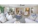 Spacious living room with multiple seating areas and large windows at 2267 Heron Cir, Clearwater, FL 33762
