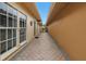 Long side yard with brick pavers, offering a private walkway between the house and fence at 2267 Heron Cir, Clearwater, FL 33762