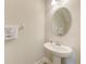 Small powder room with pedestal sink and oval mirror at 2441 Foggy Creek Cir, Clearwater, FL 33764