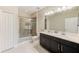 Modern bathroom with double vanity, shower, and upgraded finishes at 2441 Foggy Creek Cir, Clearwater, FL 33764