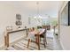 Bright dining room features a wooden table, chandelier, and access to the living room at 2441 Foggy Creek Cir, Clearwater, FL 33764