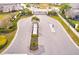 Aerial view of gated community entrance with landscaping and guardhouse at 2441 Foggy Creek Cir, Clearwater, FL 33764