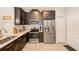 Modern kitchen with stainless steel appliances and dark cabinetry at 2441 Foggy Creek Cir, Clearwater, FL 33764