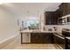 Open kitchen features stainless steel appliances and an island at 2441 Foggy Creek Cir, Clearwater, FL 33764
