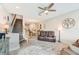 Living room with brown leather reclining sofas and a view of the staircase at 2441 Foggy Creek Cir, Clearwater, FL 33764