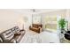 Cozy living room with leather couches and sliding glass doors leading to backyard at 2441 Foggy Creek Cir, Clearwater, FL 33764