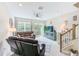 Relaxing living room with leather sofas, large TV, and sliding glass doors at 2441 Foggy Creek Cir, Clearwater, FL 33764
