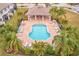 Community pool with plenty of lounge chairs and a covered patio at 2441 Foggy Creek Cir, Clearwater, FL 33764