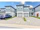 Front view of townhouses with gray siding and pavered driveways at 2441 Foggy Creek Cir, Clearwater, FL 33764