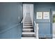 View of a staircase with white risers and dark wood treads at 262 4Th N Ave, St Petersburg, FL 33701