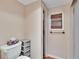 Clean bathroom with toilet, shower, and linen storage at 3022 Short Leaf St, Wesley Chapel, FL 33543