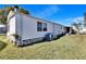 Side view of a manufactured home with AC unit at 3022 Short Leaf St, Wesley Chapel, FL 33543