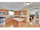 Spacious kitchen with island, stainless steel appliances, and light wood cabinets at 3022 Short Leaf St, Wesley Chapel, FL 33543